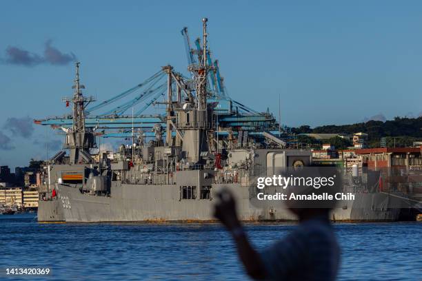 Man takes picture at the harbour where Taiwanese Navy warships are anchored on August 07, 2022 in Keelung, Taiwan. Taiwan remained tense after...