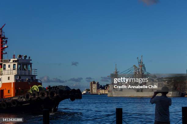 Man takes picture at the harbour where Taiwanese Navy warships are anchored on August 07, 2022 in Keelung, Taiwan. Taiwan remained tense after...