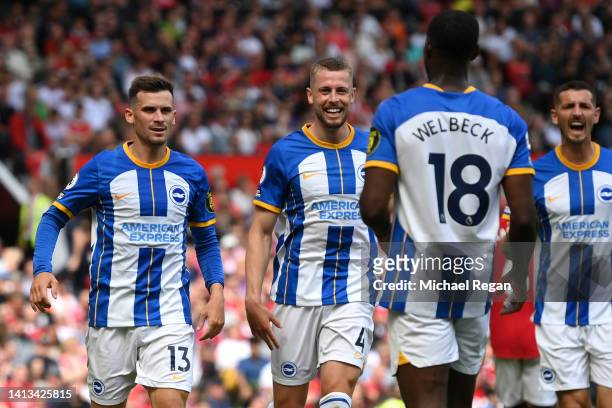 Pascal Gross of Brighton & Hove Albion celebrates with Adam Webster and Danny Welbeck after scoring their team's first goal during the Premier League...