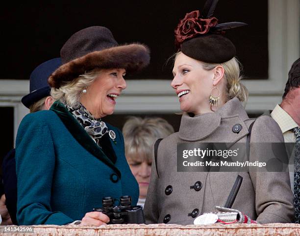 Camilla, Duchess of Cornwall and Zara Phillips watch the 'Queen Mother Champion Steeple Chase' horse race on day 2 'Ladies Day' of the Cheltenham...