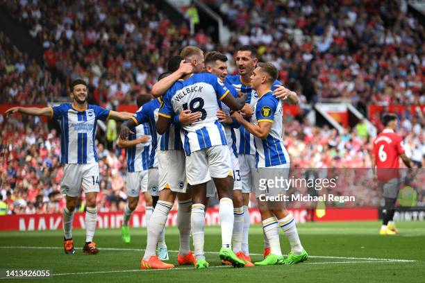 Pascal Gross of Brighton & Hove Albion celebrates with teammates after scoring their team's first goal during the Premier League match between...
