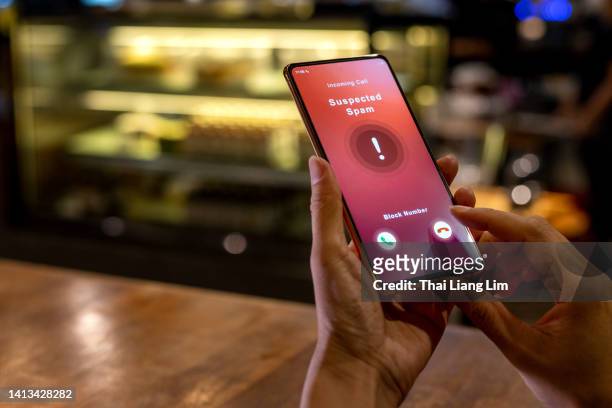 person receiving suspected spam call on smartphone from an unknown caller - tech start up stock pictures, royalty-free photos & images
