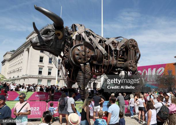 Members of the public crowd around the giant mechanical bull on day ten of the Birmingham 2022 Commonwealth Games in Birmingham's Centenary Square on...