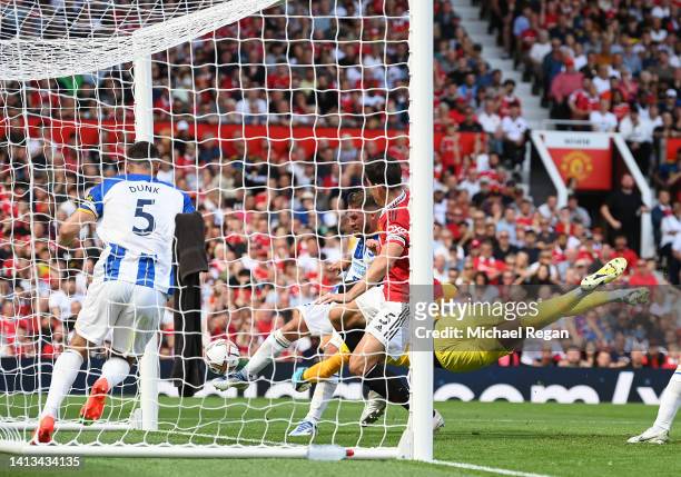 Alexis Mac Allister of Brighton & Hove Albion scores an own goal, the first goal for Manchester United during the Premier League match between...