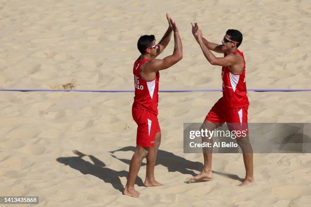 Javier Bello and Joaquin Bello of Team England celebrate a point against Team Rwanda during the Men's Beach Volleyball Bronze Medal match on day ten...