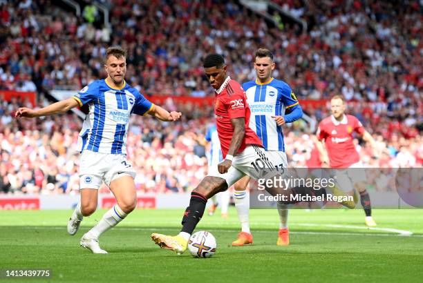 Marcus Rashford of Manchester United is put under pressure by Joel Veltman of Brighton & Hove Albion during the Premier League match between...
