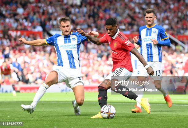 Marcus Rashford of Manchester United is put under pressure by Joel Veltman of Brighton & Hove Albion during the Premier League match between...