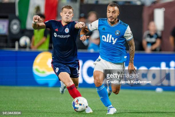 Chris Mueller of Chicago Fire challenges Andre Shinyashiki of Charlotte FC for the ball during their game at Bank of America Stadium on August 06,...