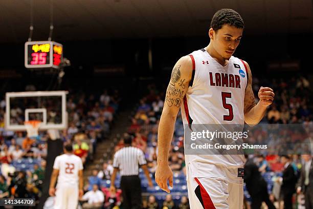 Mike James of the Lamar Cardinals walks towards the bench in the second half after he fouled out against the Vermont Catamounts in the first round of...