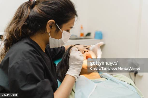 dentist examining patient - medical procedure stock pictures, royalty-free photos & images