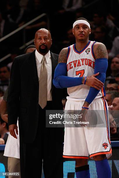 Mike Woodson the interim head coach of the New York Knicks looks on with Carmelo Anthony of the New York Knicks during the game against the Portland...