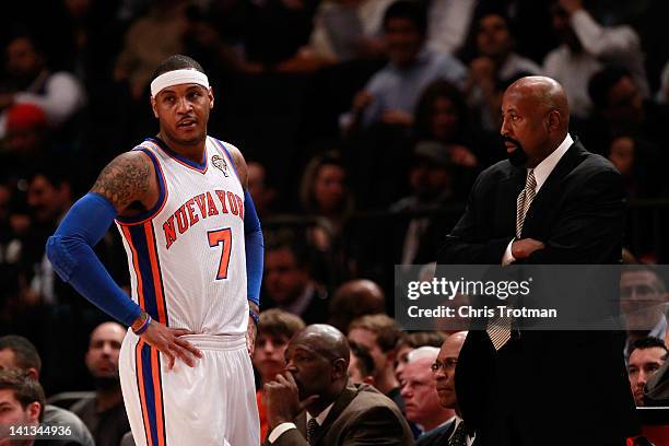 Mike Woodson the interim head coach of the New York Knicks looks on with Carmelo Anthony of the New York Knicks during the game against the Portland...