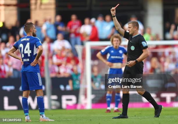 Referee, Robert Schroder shows Dominick Drexler of FC Schalke 04 a red card during the Bundesliga match between 1. FC Köln and FC Schalke 04 at...