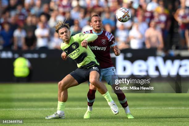 Jack Grealish of Manchester City and Vladimir Coufal of West Ham United battle for the ball during the Premier League match between West Ham United...