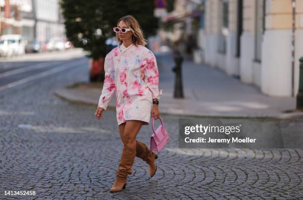 Karin Teigl wearing Isabel Marant mini pastel denim dress, Isabel Marant beige leather boots, Jacquemus Chiquito rose bag and Loewe white rose shades...