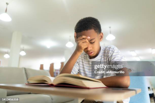 kid with sight problems trying to read book in class - eyesight problem stock pictures, royalty-free photos & images