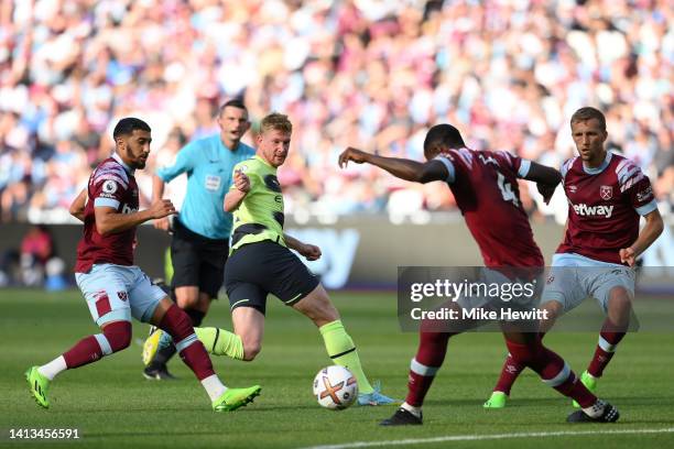 Kevin De Bruyne of Manchester City is put under pressure by Kurt Zouma and Tomas Soucek of West Ham United during the Premier League match between...