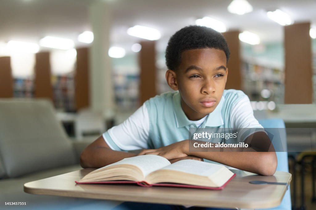 Boy sitting in class and trying to read board