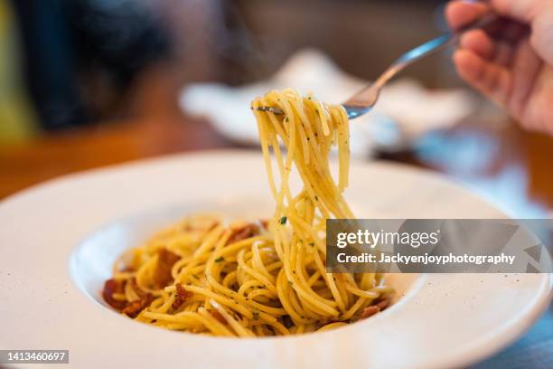 spaghetti with dried chili and bacon shot on rustic wooden table - bacon strip stock pictures, royalty-free photos & images