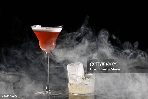 juniper manhattan cocktail and ice cup  - stock photo - tangerine martini stock pictures, royalty-free photos & images