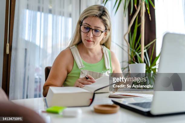adult woman taking online lessons at home - teacher preparation stock pictures, royalty-free photos & images