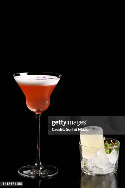 juniper manhattan cocktail and ice cup  - stock photo - tangerine martini stock pictures, royalty-free photos & images