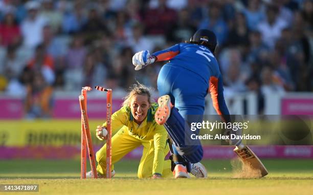 Sneh Rana of Team India is run out as Ashleigh Gardner of Team Australia removes the bails during the Cricket T20 - Gold Medal match between Team...