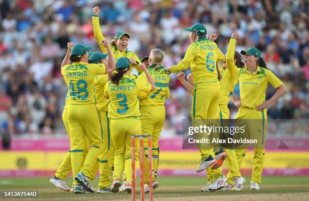 Players of Team Australia celebrate as Jess Jonassen of Team Australia takes the wicket of Taniya Bhatia of Team India to win the match and the gold...