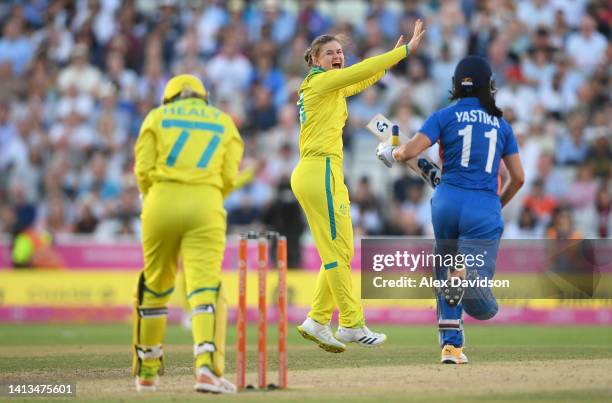 Jess Jonassen of Team Australia successfully appeals for the LBW of Taniya Bhatia of Team India to win the match and the gold medal during the...