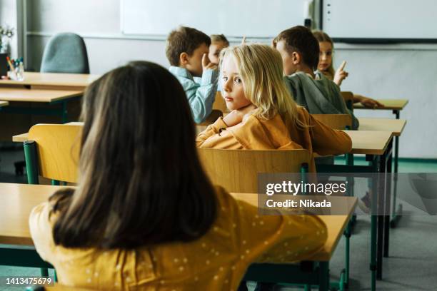 boy in elementary school classroom looking behind at his classmate - day 8 bildbanksfoton och bilder