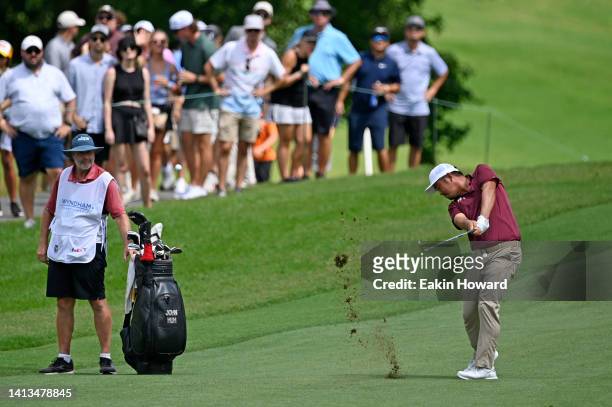 John Huh of the United States plays a second shot on the ninth hole during the final round of the Wyndham Championship at Sedgefield Country Club on...