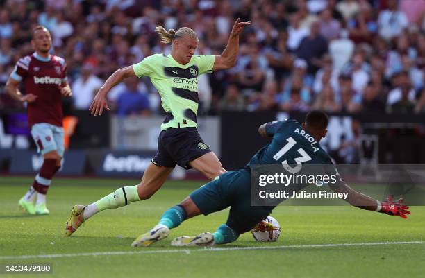 Alphonse Areola of West Ham United brings down Erling Haaland of Manchester City to concede a penalty during the Premier League match between West...