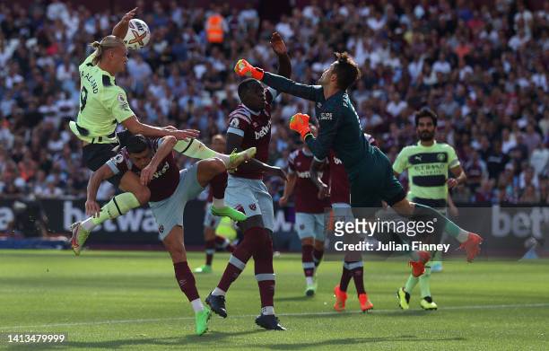 Erling Haaland of Manchester City competes for the ball with Aaron Cresswell and Lukasz Fabianski of West Ham United during the Premier League match...