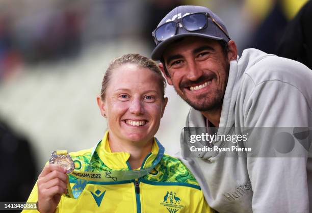 Alyssa Healy of Team Australia poses alongside Mitchell Starc after being presented with a Gold Medal during the Cricket T20 - Gold Medal match...