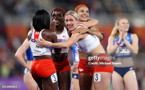 Ama Pipi, Victoria Ohuruogu, Jodie Williams and Jessie Knight of Team England celebrate winning the gold medal in the Women's 4 x 400m Relay - Final,...
