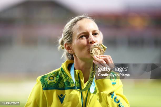 Meg Lanning of Team Australia celebrates after being presented with the Gold Medal following the Cricket T20 - Gold Medal match between Team...