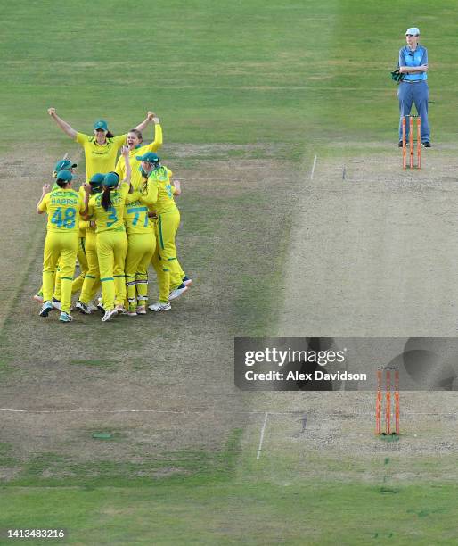 Players of Team Australia celebrate as Jess Jonassen of Team Australia takes the wicket of Taniya Bhatia of Team India to win the match and the gold...