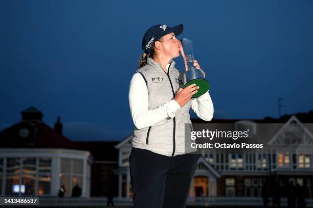 Ashleigh Buhai of South Africa poses with the AIG Women's Open trophy on the eighteenth green after winning the play-off to become the 2022 AIG...