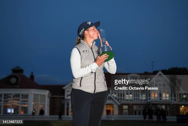 Ashleigh Buhai of South Africa poses with the AIG Women's Open trophy on the eighteenth green after winning the play-off to become the 2022 AIG...