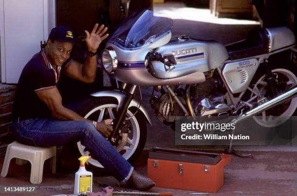 American actor and director Roger E. Mosley , smiles as he cleans his Ducati SuperSport 900 motorcycle in August 1992 in Silverlake, California....