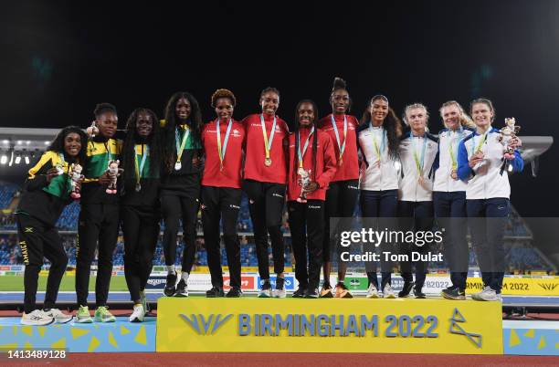 Silver medalists Team Jamaica, gold medalists Team Canada and bronze medalists Team Scotland pose for a photo during the medal ceremony for Women's 4...