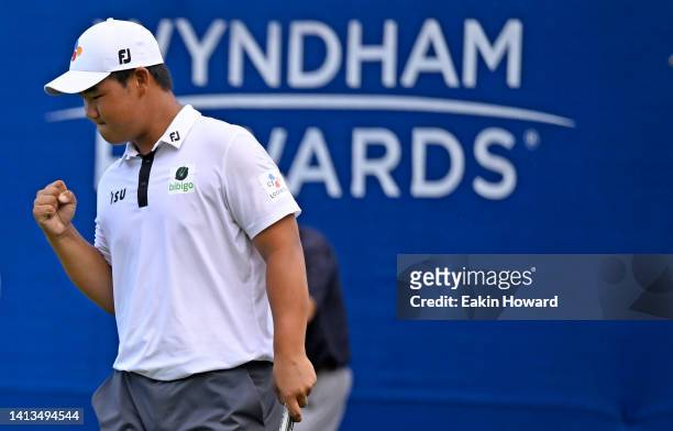 Joohyung Kim of Korea celebrates after putting in to win on the 18th green during the final round of the Wyndham Championship at Sedgefield Country...