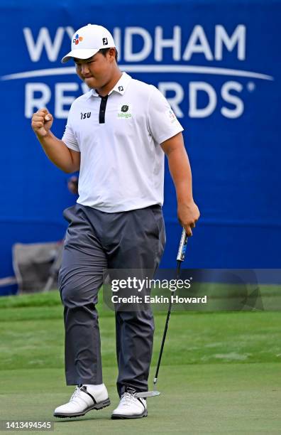 Joohyung Kim of Korea celebrates after putting in to win on the 18th green during the final round of the Wyndham Championship at Sedgefield Country...