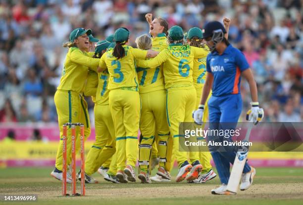 Players of Team Australia celebrate as Jess Jonassen of Team Australia takes the wicket of Taniya Bhatia of Team India to win the match and the gold...