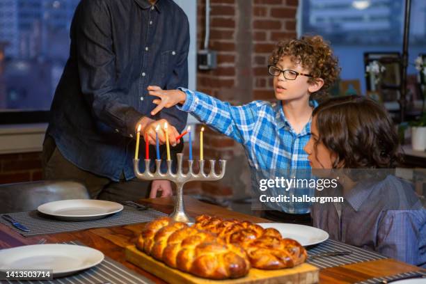 re-lighting candles during hanukkah - chanoeka stockfoto's en -beelden