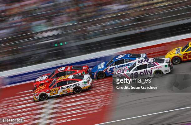 Bubba Wallace, driver of the McDonald's Toyota, Kevin Harvick, driver of the Busch Light Apple #BuschelOfBusch Ford, Kyle Larson, driver of the...