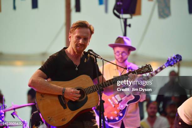 Actor and musician Damian Lewis performs on stage during the Wilderness Festival at Cornbury Park on August 07, 2022 in Charlbury, United Kingdom.