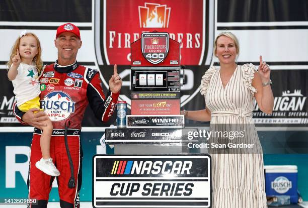 Kevin Harvick, driver of the Busch Light Apple #BuschelOfBusch Ford, celebrates with his wife, DeLana Harvick and daughter, Piper in victory lane...