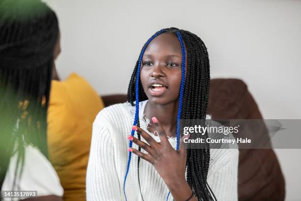 teenage girl having a serious conversation with mother - braided hairstyles for african american girls stock pictures, royalty-free photos & images