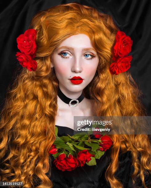 redhead fabulous woman. long curly hair. pale skin. girl in choker and black dress on dark background. beautiful model with red lips. renaissance outfit. hairstyle. jewelry and bijouterie. rose flower - flowers royalty free stock pictures, royalty-free photos & images